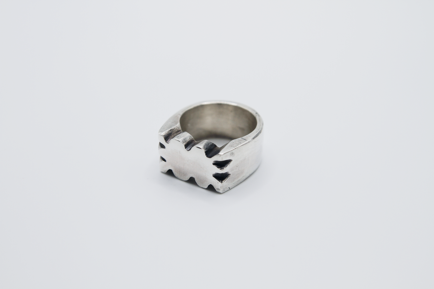 The Nibble Ring. 925 Solid Sterling Silver Chunky Ring band hand made in the United Kingdom. This ring has a wavy and unique design, displaying a wiggly edged design in the centre of the ring face. For all genders and ring sizes.