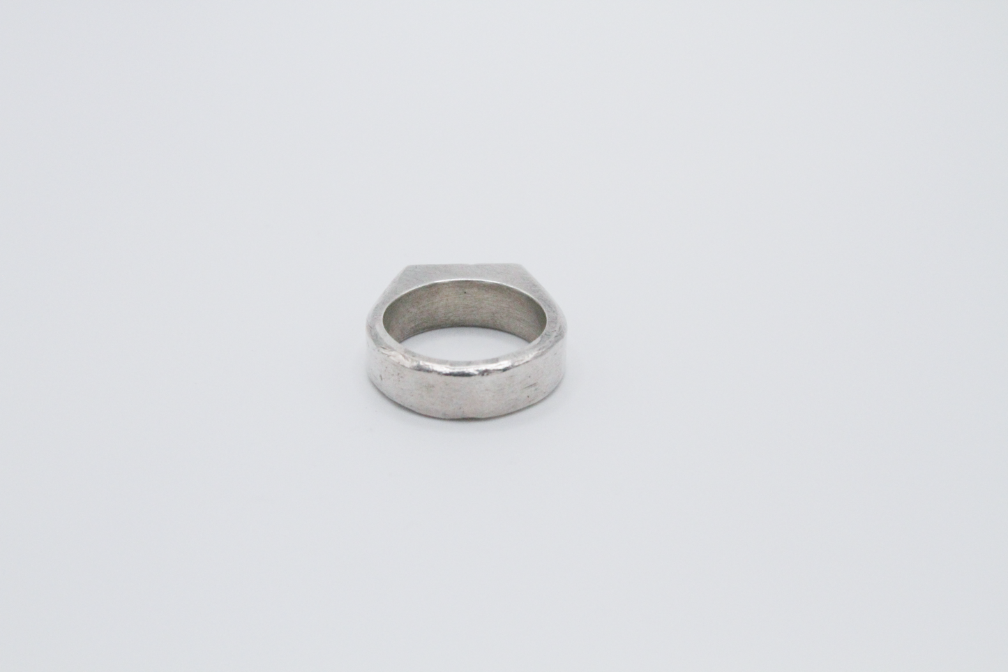 The Rough Cut Initials Ring. 925 Solid Sterling Silver Chunky Ring band hand made in the United Kingdom. This Signet ring is designed to sit on your pinky finger as they are classicaly worn. Put your initials in places of a coat of arms. For all genders and ring sizes.