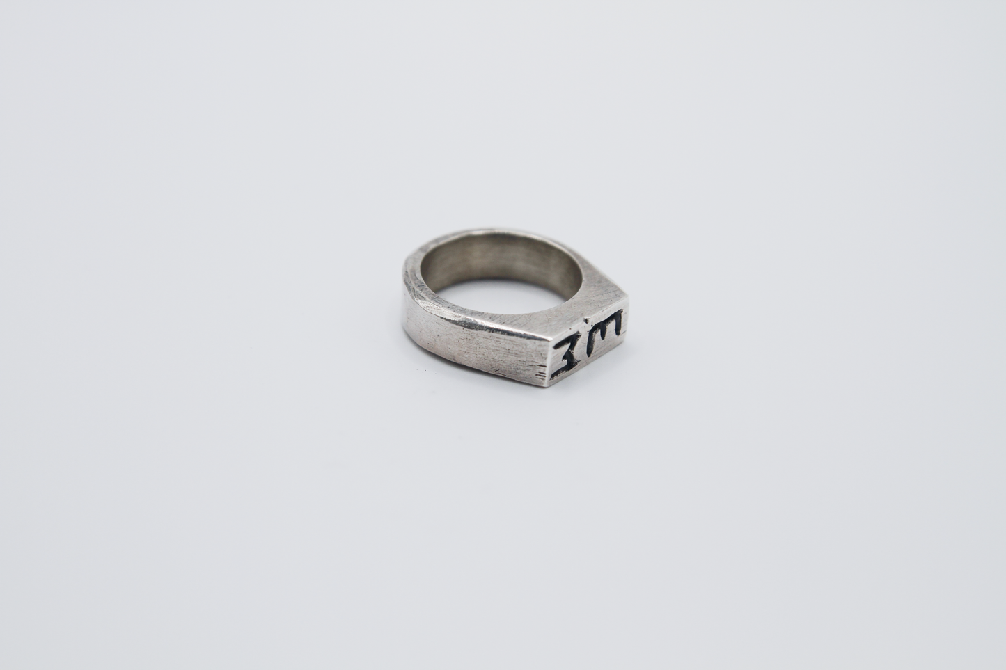 The Rough Cut Initials Ring. 925 Solid Sterling Silver Chunky Ring band hand made in the United Kingdom. This Signet ring is designed to sit on your pinky finger as they are classicaly worn. Put your initials in places of a coat of arms. For all genders and ring sizes.