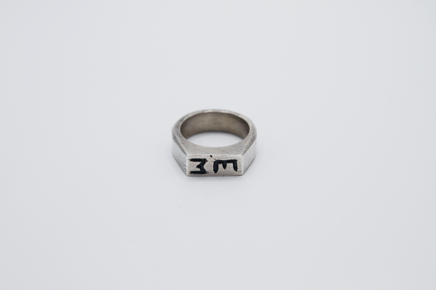 The Rough Cut Initials Ring. 925 Solid Sterling Silver Chunky Ring band hand made in the United Kingdom. This Signet ring is designed to sit on your pinky finger as they are classicaly worn. Put your initials in places of a coat of arms. For all genders and ring sizes.