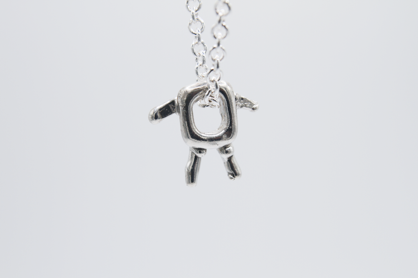 The Square Boy Pendant Necklace. 925 Solid Sterling Silver Pendant Necklace hand made in the United Kingdom. This necklace displays a Square pendant with arms and legs in solid sterling silver. This pendant sits on an 18 inch trace chain. For all genders.