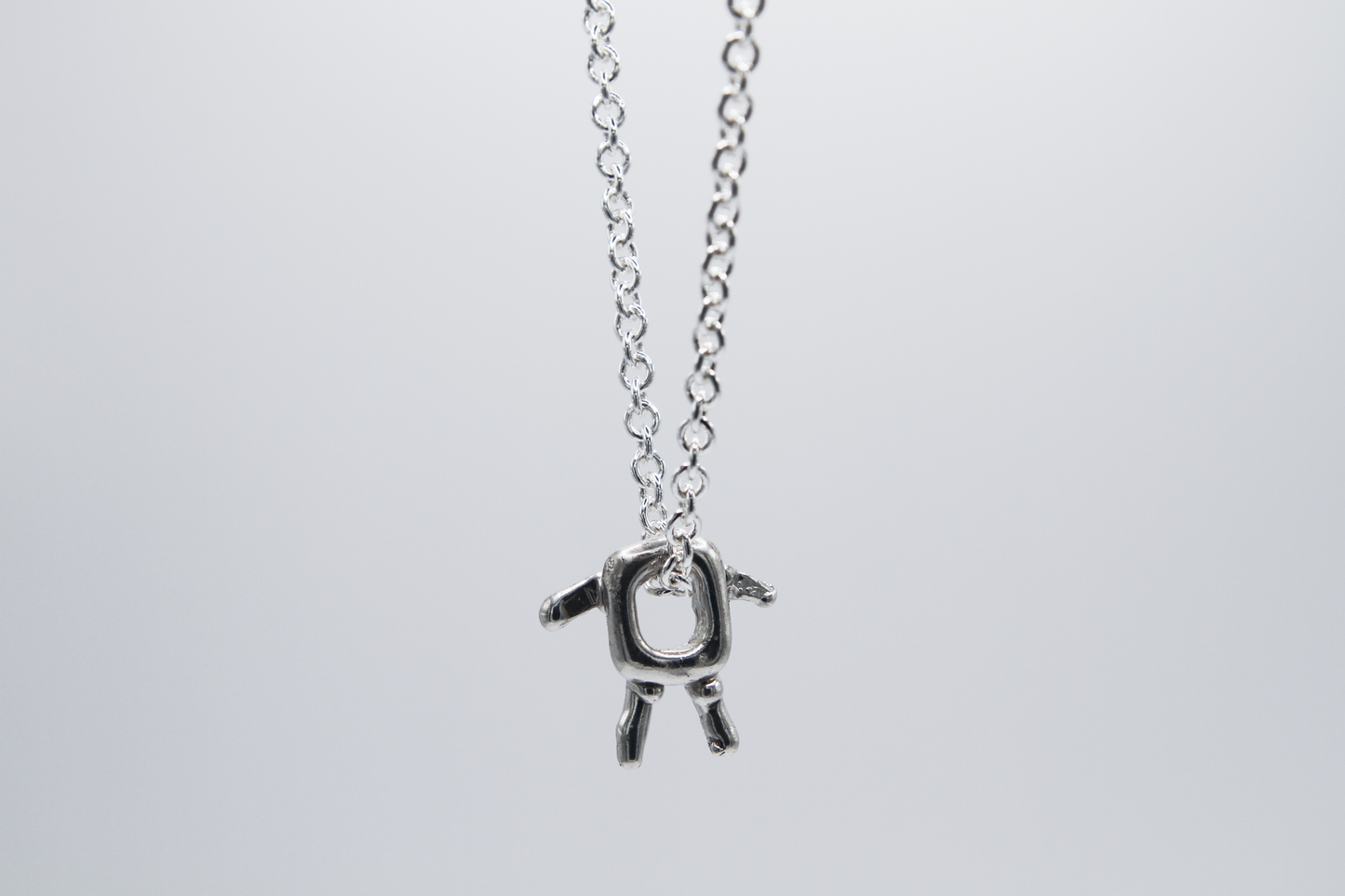 The Square Boy Pendant Necklace. 925 Solid Sterling Silver Pendant Necklace hand made in the United Kingdom. This necklace displays a Square pendant with arms and legs in solid sterling silver. This pendant sits on an 18 inch trace chain. For all genders.