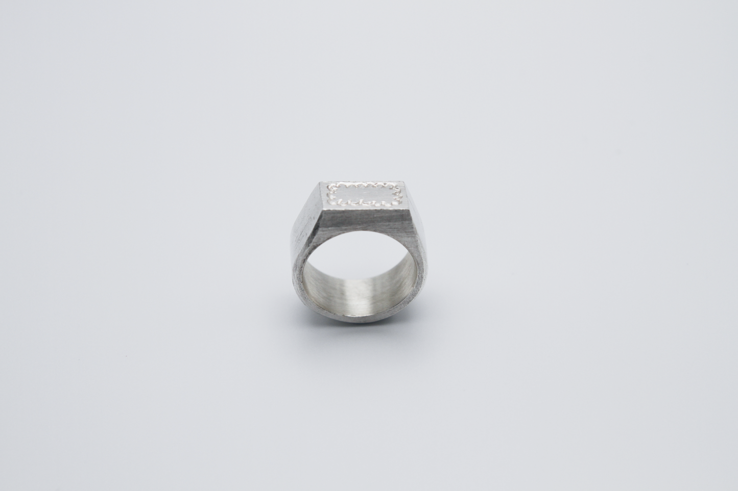 The Doodle Signet Ring. 925 Solid Sterling Silver Chunky Ring band hand made in the United Kingdom. This ring has a classic flat face displaying a wiggly and unique doodle design in the shape of a box on the front of the ring. For all genders and ring sizes.