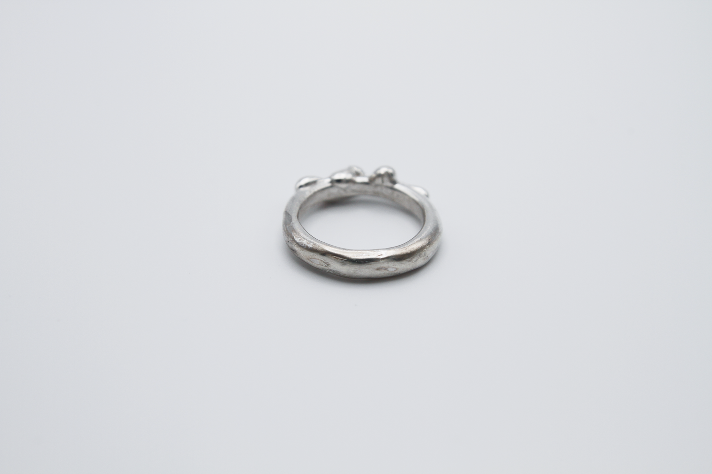 The Treacle Ring Band. 925 Solid Sterling Silver Ring band hand made in the United Kingdom. This ring has a melted look to it, driping sterling silver on the ring face. For all genders and ring sizes.