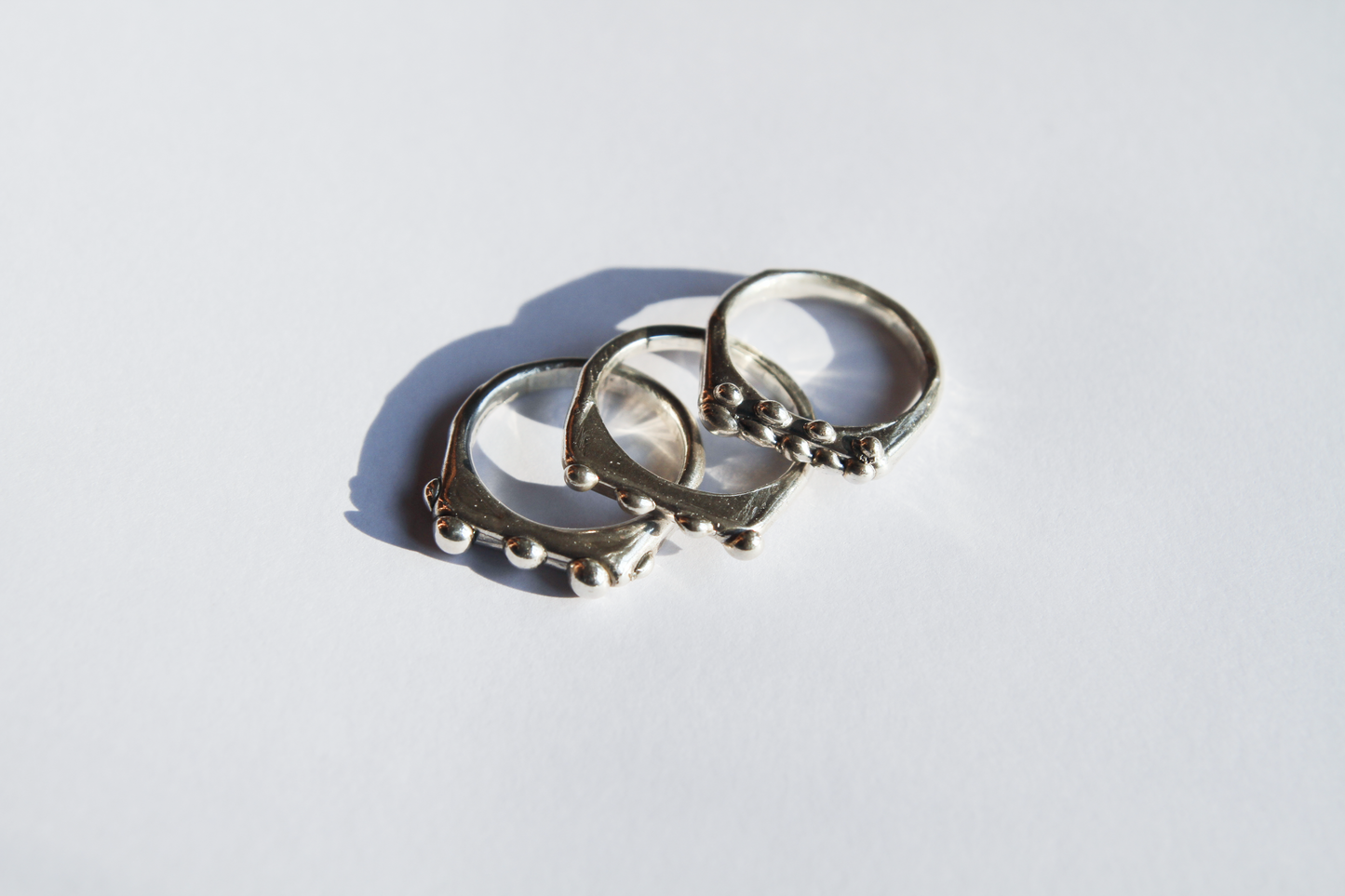 The Dew Drop Signet Ring Stack. 925 Solid Sterling Silver Chunky Ring band hand made in the United Kingdom. These stacking rings fashion blobs and drops of sterling silver in a bespoke and organic deisgn. Stack these three rings however you like, to be worn together or separately. For all genders and ring sizes.