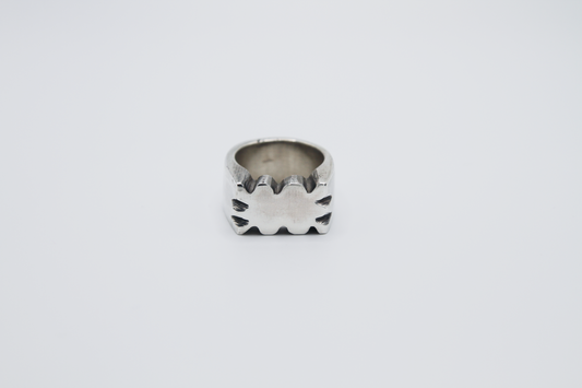 The Nibble Ring. 925 Solid Sterling Silver Chunky Ring band hand made in the United Kingdom. This ring has a wavy and unique design, displaying a wiggly edged design in the centre of the ring face. For all genders and ring sizes.
