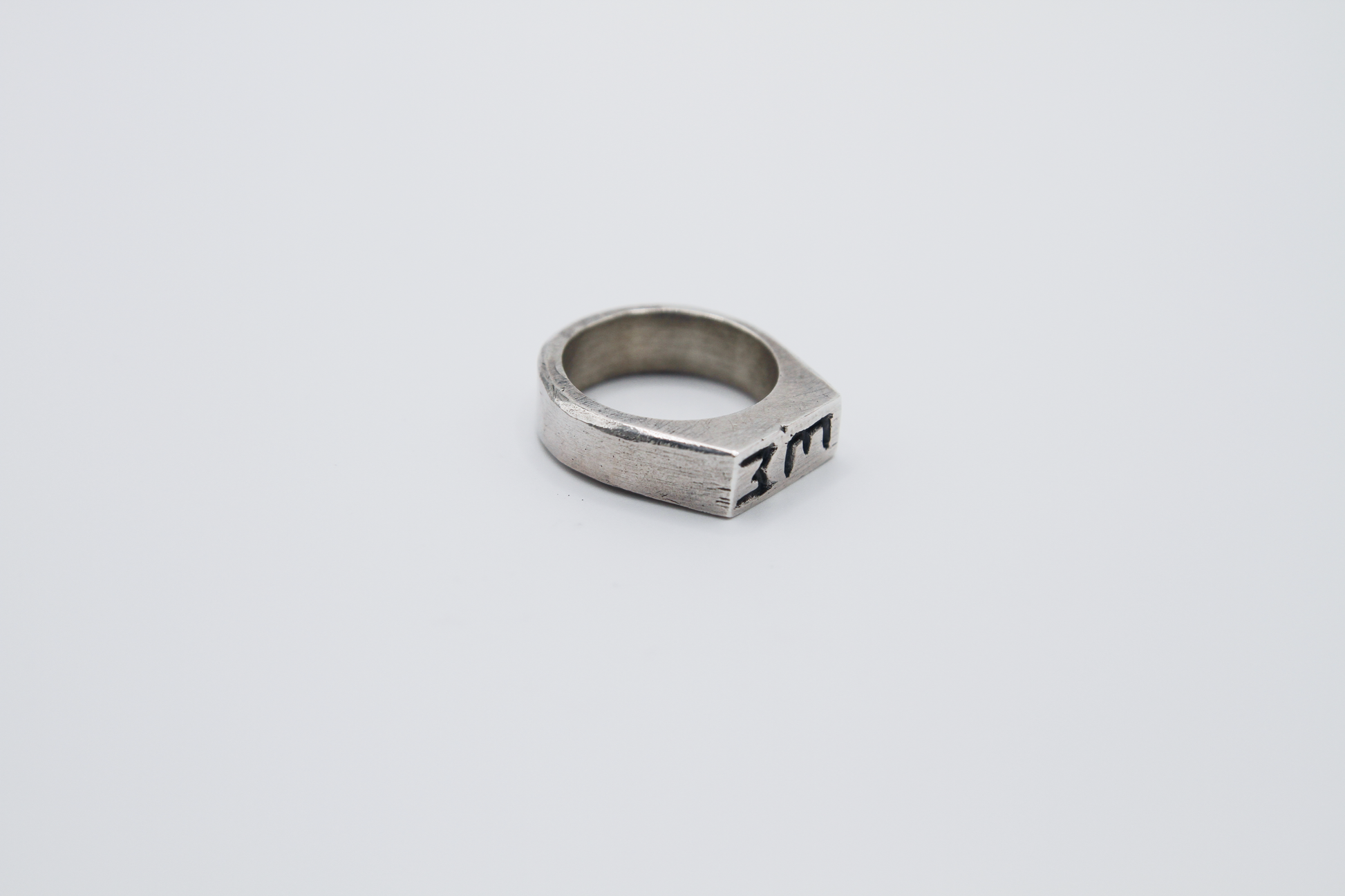The Rough Cut Initials Ring. 925 Solid Sterling Silver Chunky Ring band hand made in the United Kingdom. This Signet ring is designed to sit on your pinky finger as they are classicaly worn. Put your initials in places of a coat of arms. For all genders and ring sizes.