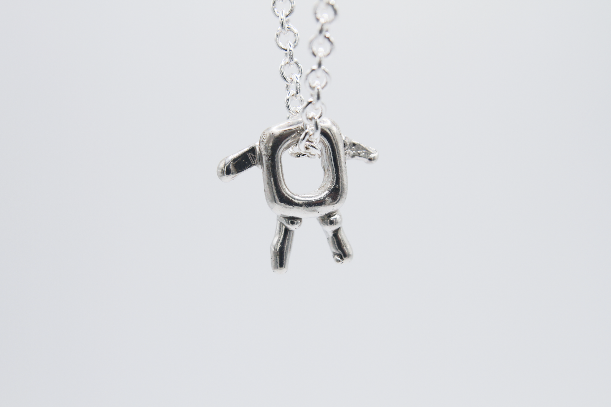 The Square Boy Pendant Necklace. 925 Solid Sterling Silver Pendant Necklace hand made in the United Kingdom. This necklace displays a Square pendant with arms and legs in solid sterling silver. This pendant sits on an 18 inch trace chain. For all genders.