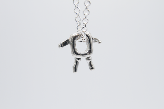 The Square Boy Pendant Necklace. 925 Solid Sterling Silver Pendant Necklace hand made in the United Kingdom. This necklace displays a Square pendant with arms and legs in solid sterling silver. This pendant sits on an 18 inch trace chain. For all genders.