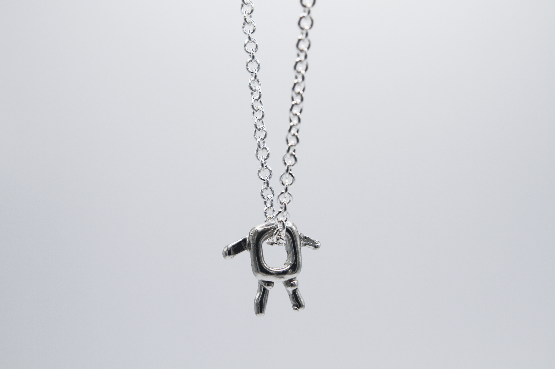 The Square Boy Pendant Necklace. 925 Solid Sterling Silver Pendant Necklace hand made in the United Kingdom. This necklace displays a Square pendant with arms and legs in solid sterling silver. This pendant sits on an 18 inch trace chain. For all genders.