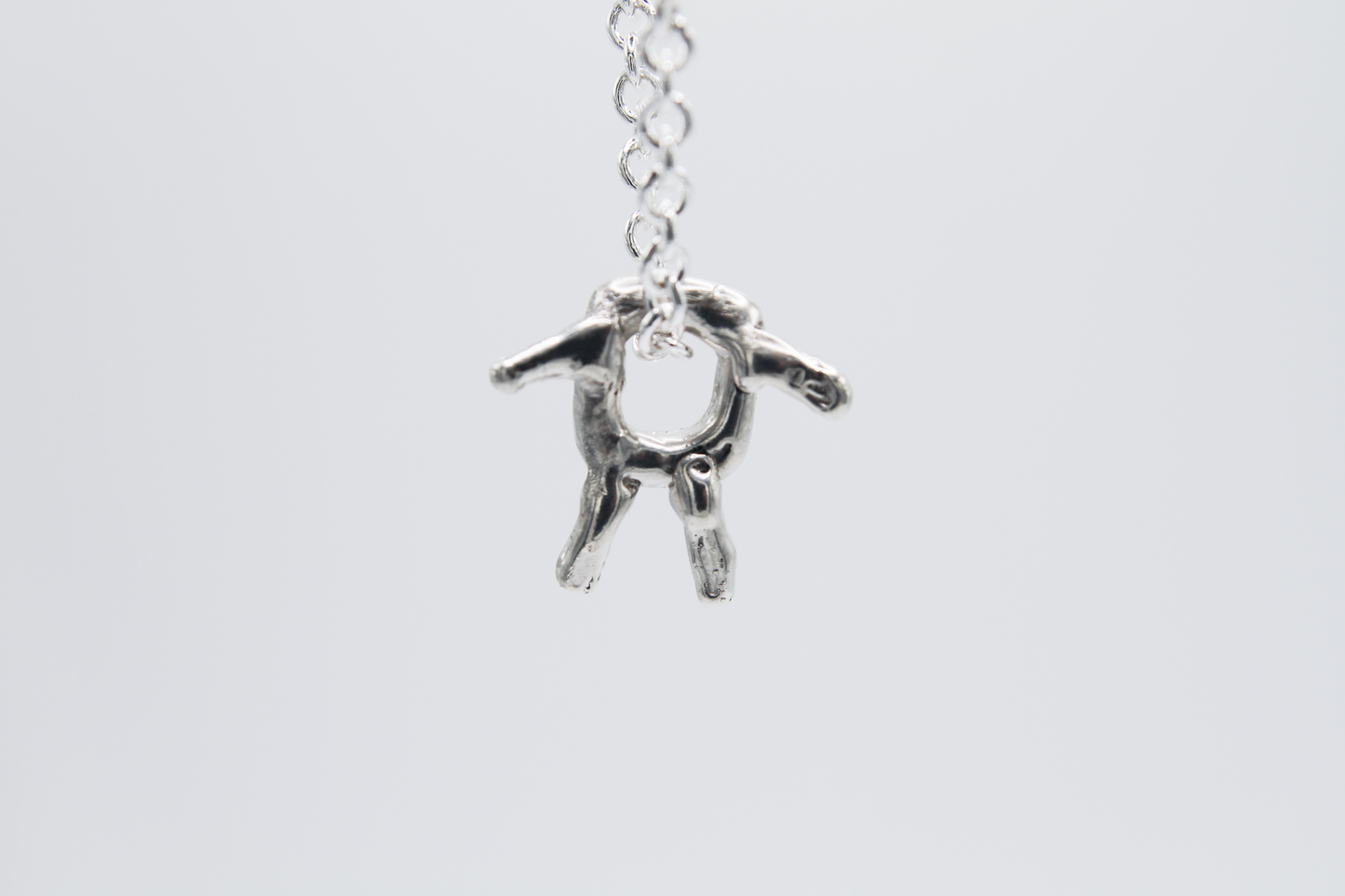 The Square Boy Pendant Necklace. 925 Solid Sterling Silver Pendant Necklace hand made in the United Kingdom. This necklace displays a Square pendant with arms and legs in solid sterling silver. This pendant sits on an 18 inch trace chain. For all genders.