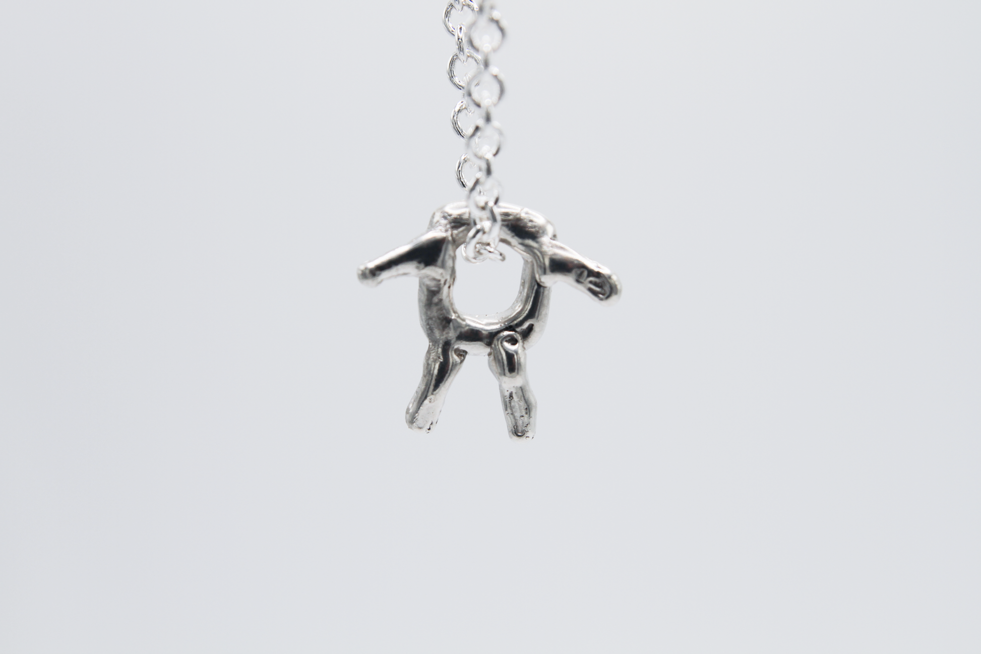 The Square Boy Pendant Necklace. 925 Solid Sterling Silver Pendant Necklace hand made in the United Kingdom. This necklace displays a Square pendant with arms and legs in solid sterling silver. This pendant sits on an 18 inch trace chain. For all genders.
