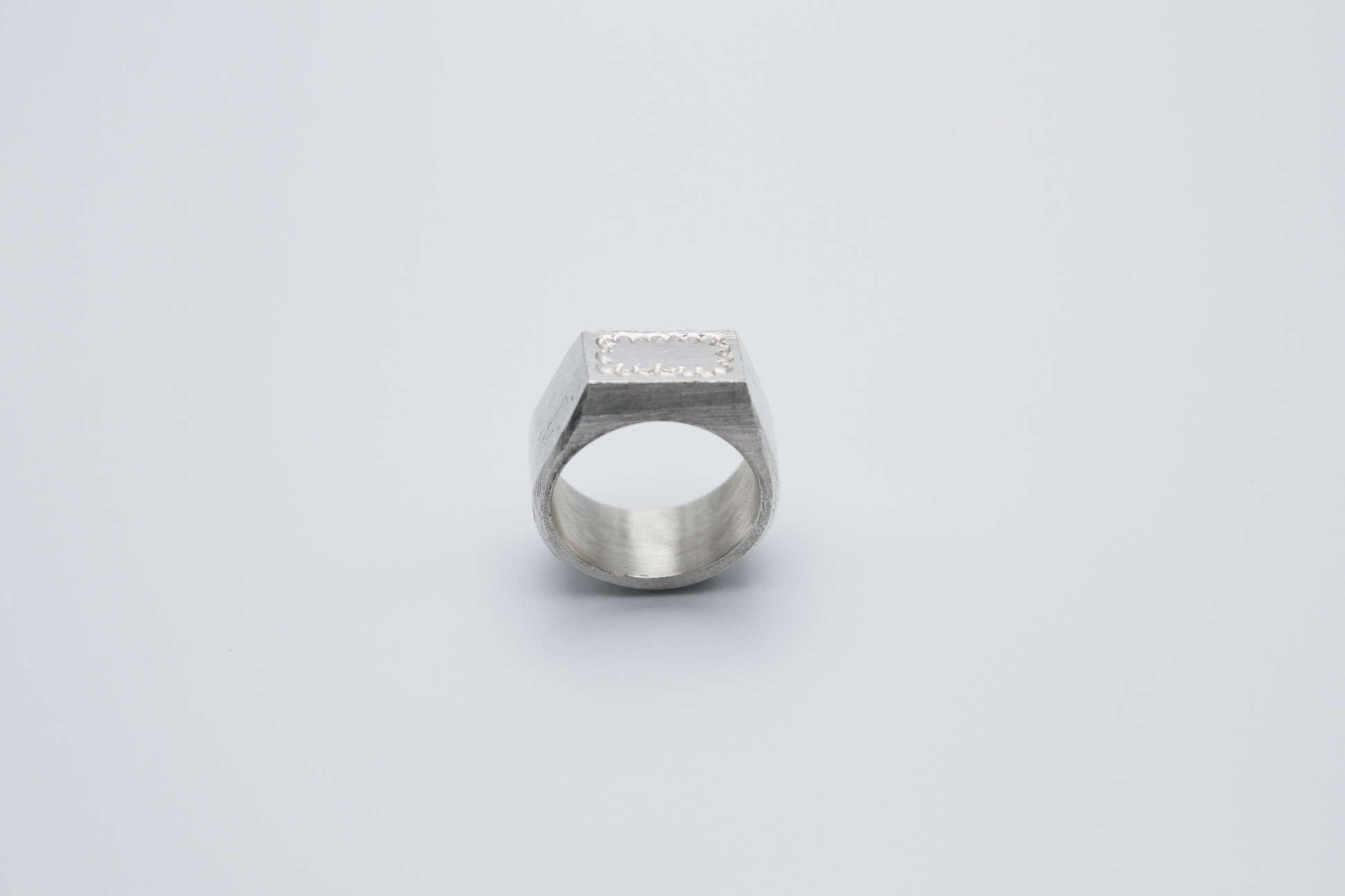 The Doodle Signet Ring. 925 Solid Sterling Silver Chunky Ring band hand made in the United Kingdom. This ring has a classic flat face displaying a wiggly and unique doodle design in the shape of a box on the front of the ring. For all genders and ring sizes.