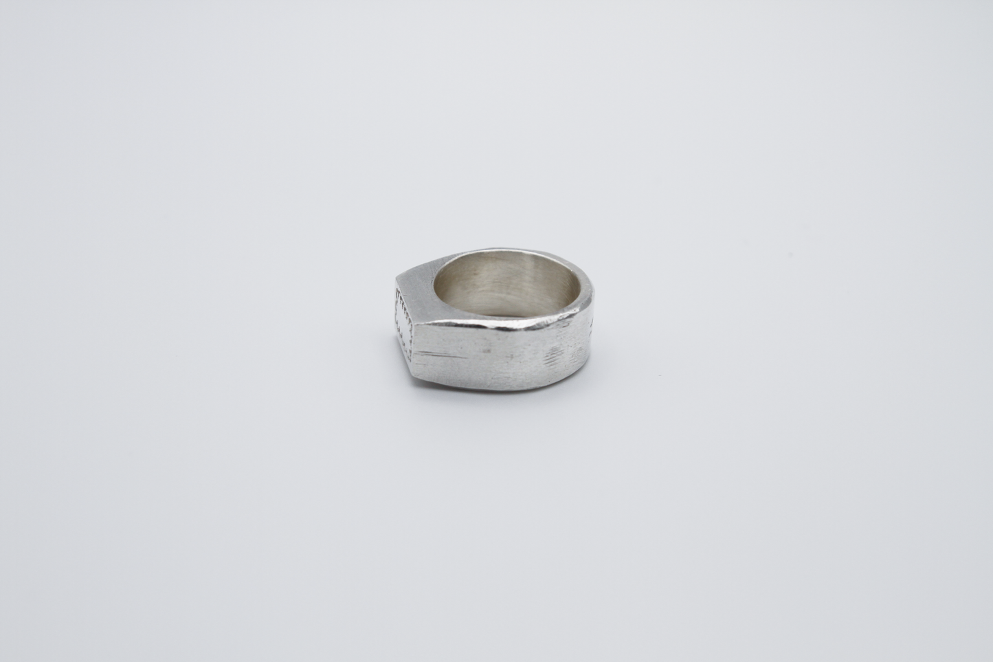 The Doodle Signet Ring. 925 Solid Sterling Silver Chunky Ring band hand made in the United Kingdom. This ring has a classic flat face displaying a wiggly and unique doodle design in the shape of a box on the front of the ring. For all genders and ring sizes.