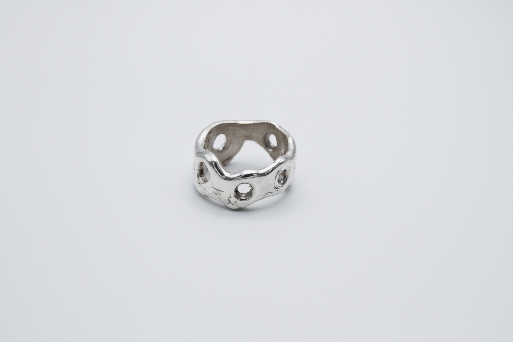 The Honeycomb Ring. 925 Solid Sterling Silver Chunky Ring band hand made in the United Kingdom. This ring has a melted look to it, with windows and eyelets throughout. For all genders and ring sizes.