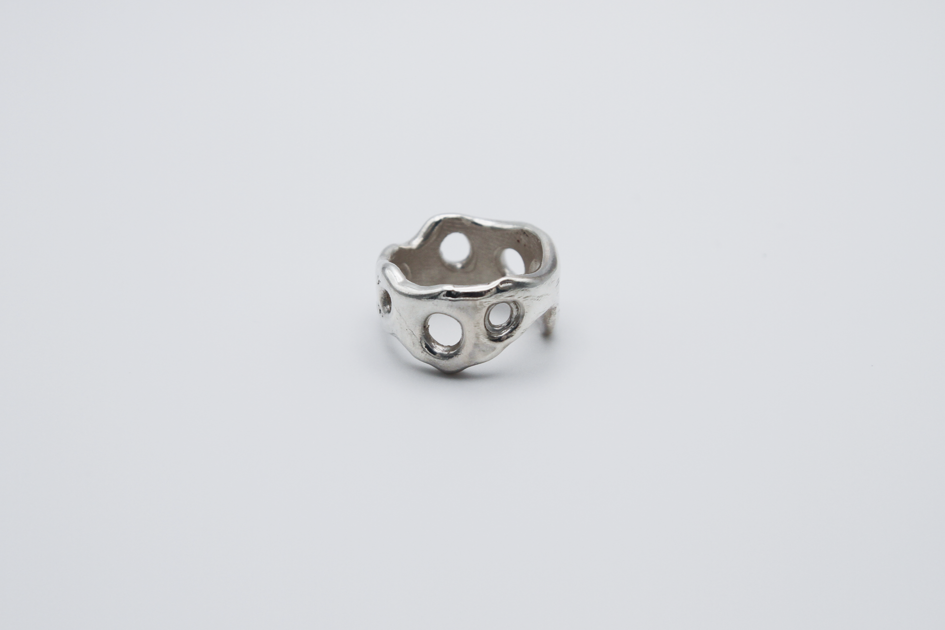 The Honeycomb Ring. 925 Solid Sterling Silver Chunky Ring band hand made in the United Kingdom. This ring has a melted look to it, with windows and eyelets throughout. For all genders and ring sizes.