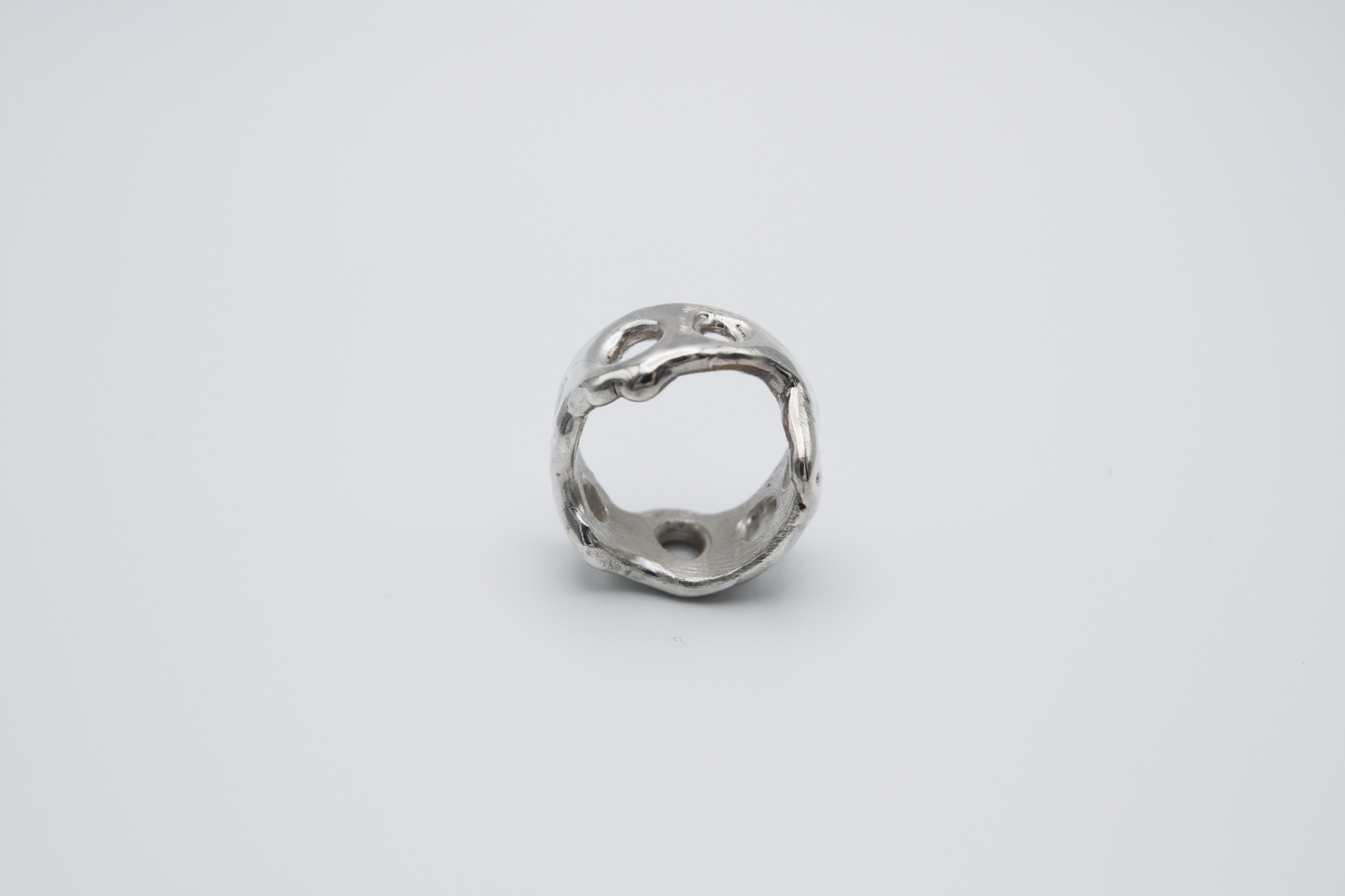 The Honeycomb Ring. 925 Solid Sterling Silver Chunky Ring band hand made in the United Kingdom. This ring has a melted look to it, with windows and eyelets throughout. For all genders and ring sizes.