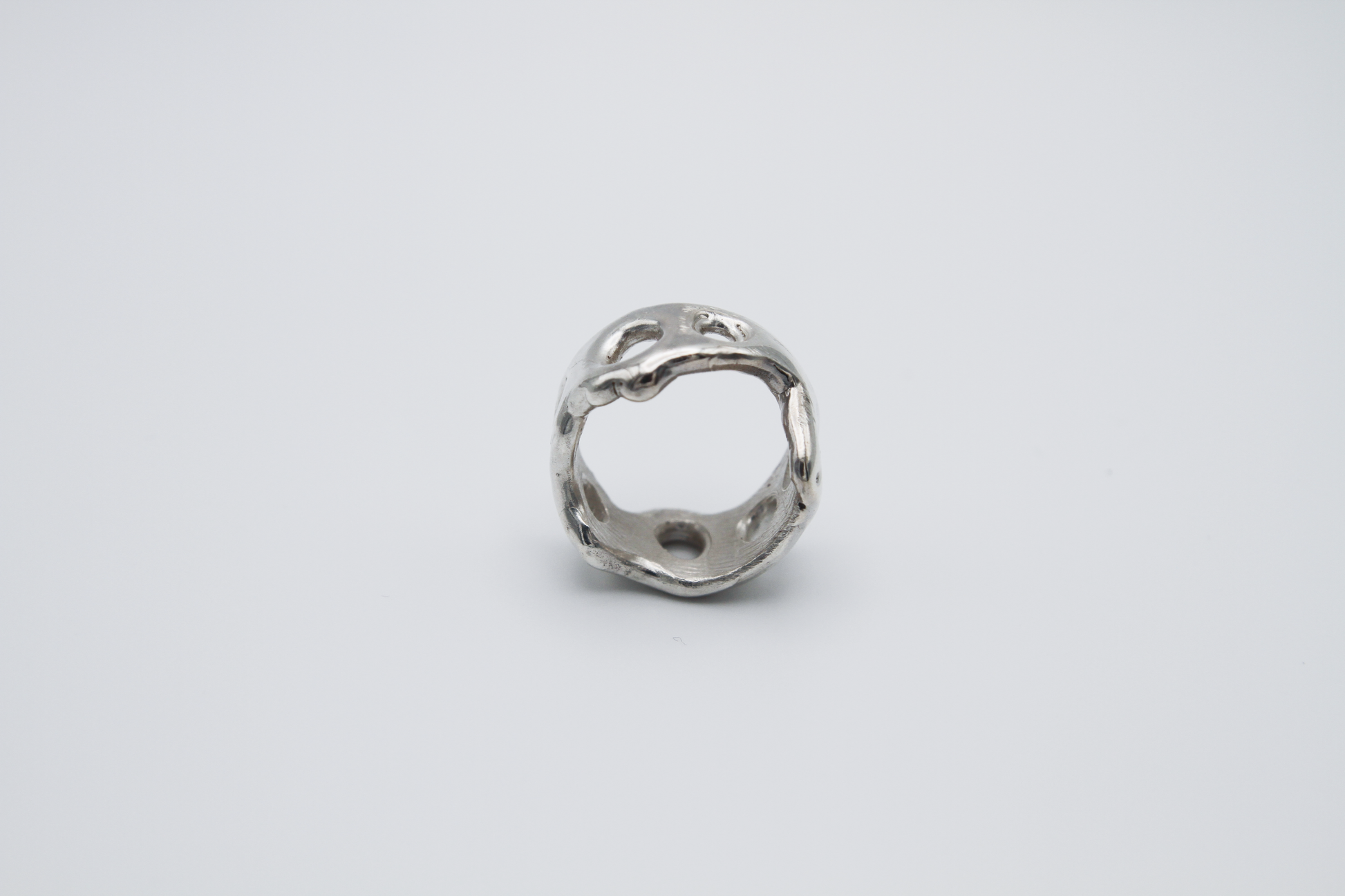 The Honeycomb Ring. 925 Solid Sterling Silver Chunky Ring band hand made in the United Kingdom. This ring has a melted look to it, with windows and eyelets throughout. For all genders and ring sizes.