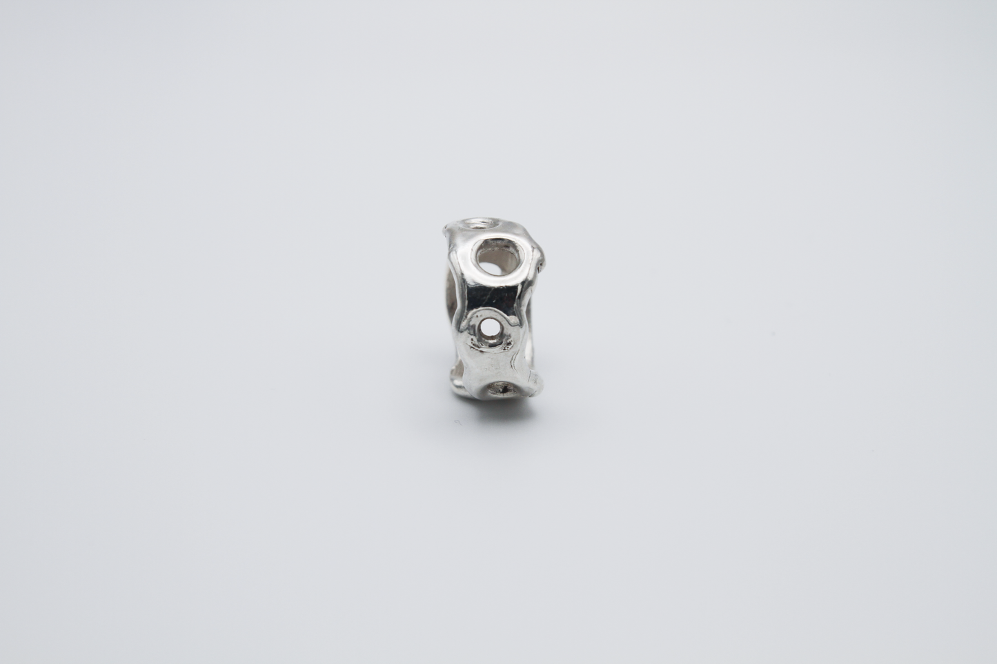 The Honeycomb Ring. 925 Solid Sterling Silver Chunky Ring band hand made in the United Kingdom. This ring has a melted look to it, with windows and eyelets throughout. For all genders and ring sizes.