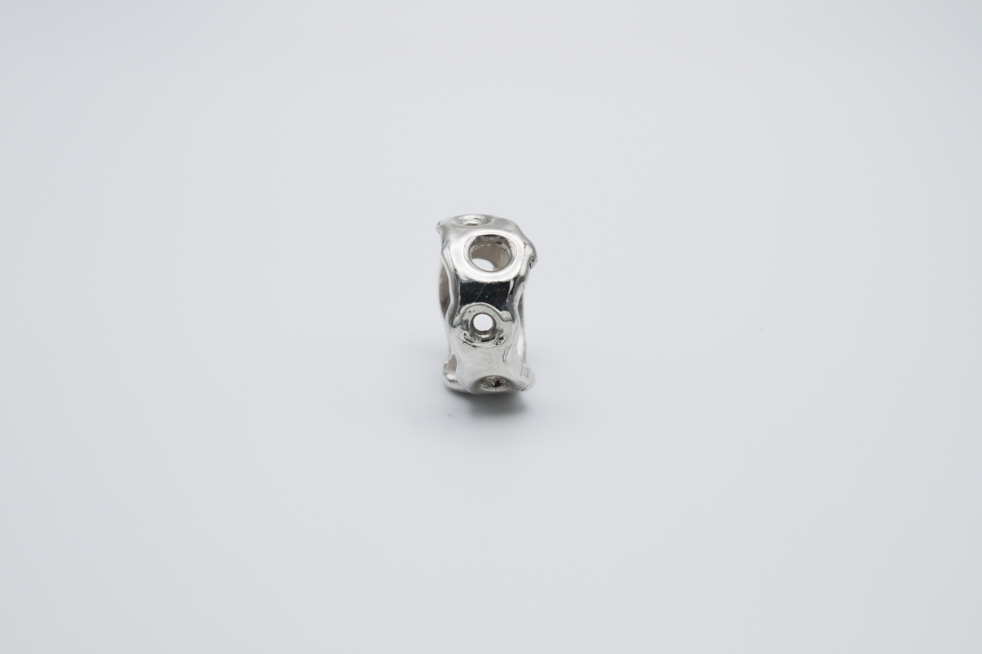 The Honeycomb Ring. 925 Solid Sterling Silver Chunky Ring band hand made in the United Kingdom. This ring has a melted look to it, with windows and eyelets throughout. For all genders and ring sizes.