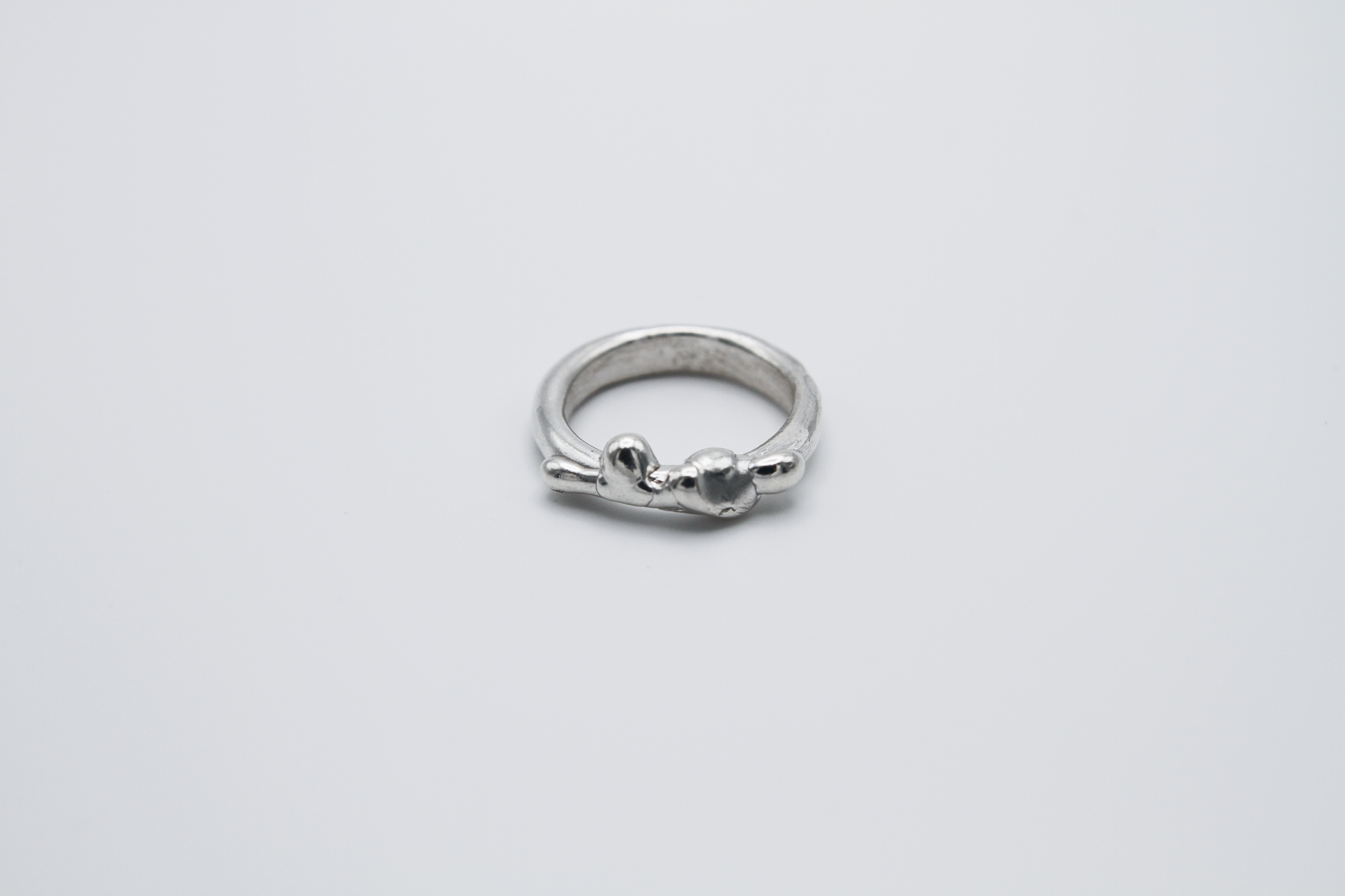 The Treacle Ring Band. 925 Solid Sterling Silver Ring band hand made in the United Kingdom. This ring has a melted look to it, driping sterling silver on the ring face. For all genders and ring sizes.