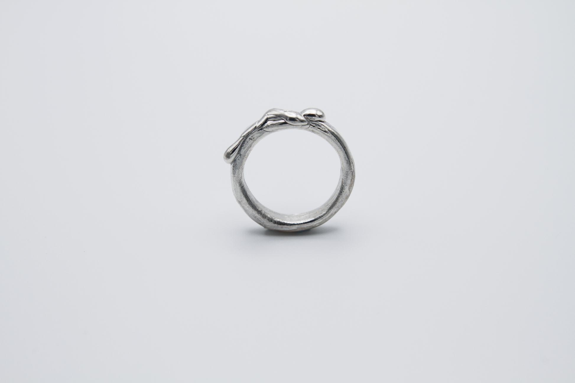The Treacle Ring Band. 925 Solid Sterling Silver Ring band hand made in the United Kingdom. This ring has a melted look to it, driping sterling silver on the ring face. For all genders and ring sizes.