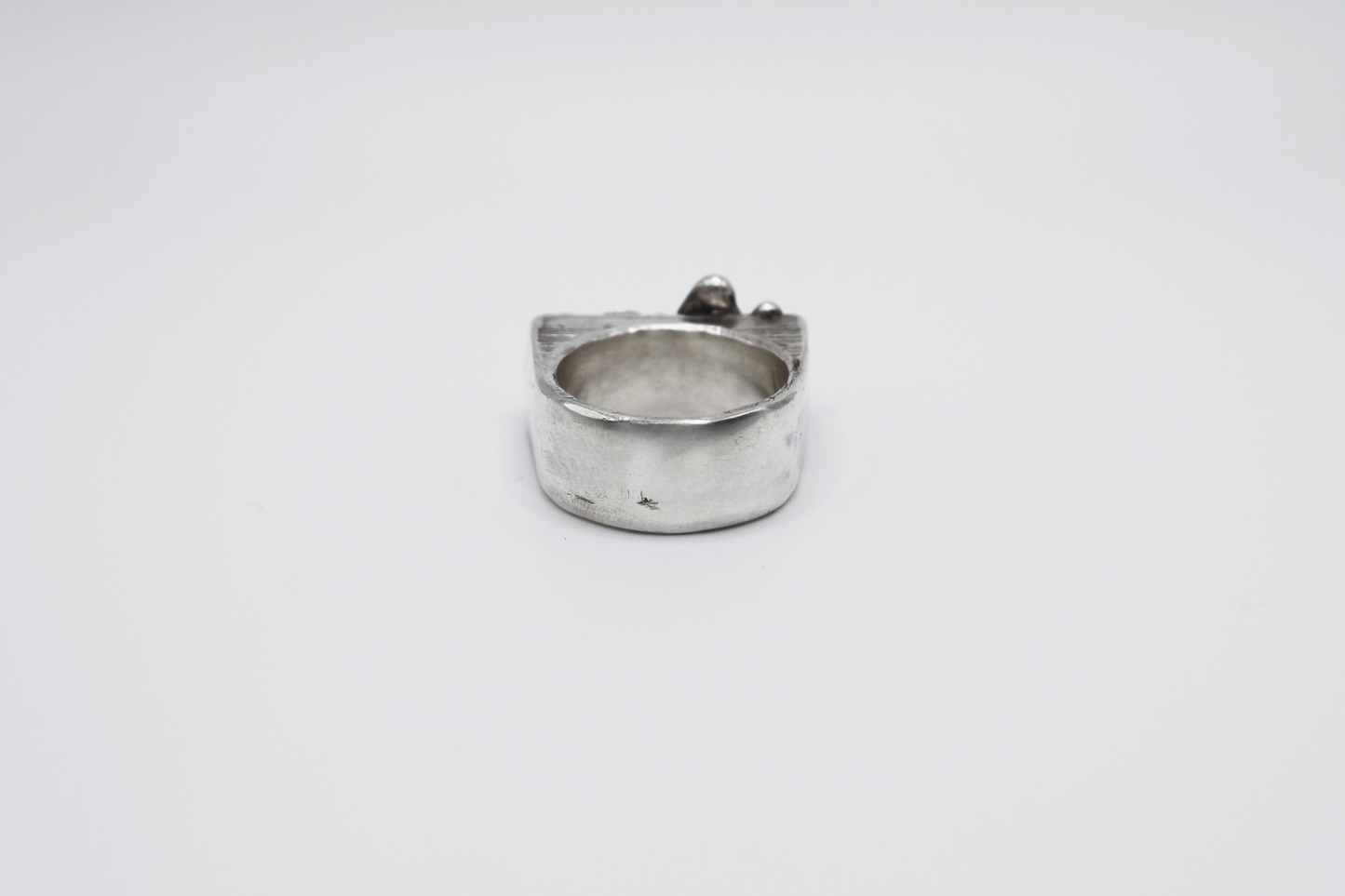 The Treacle Signet Ring. 925 Solid Sterling Silver Chunky Ring hand made in the United Kingdom. This ring has a rectangular face with drips of sterling silver giving a melted and organic look. For all genders and ring sizes.