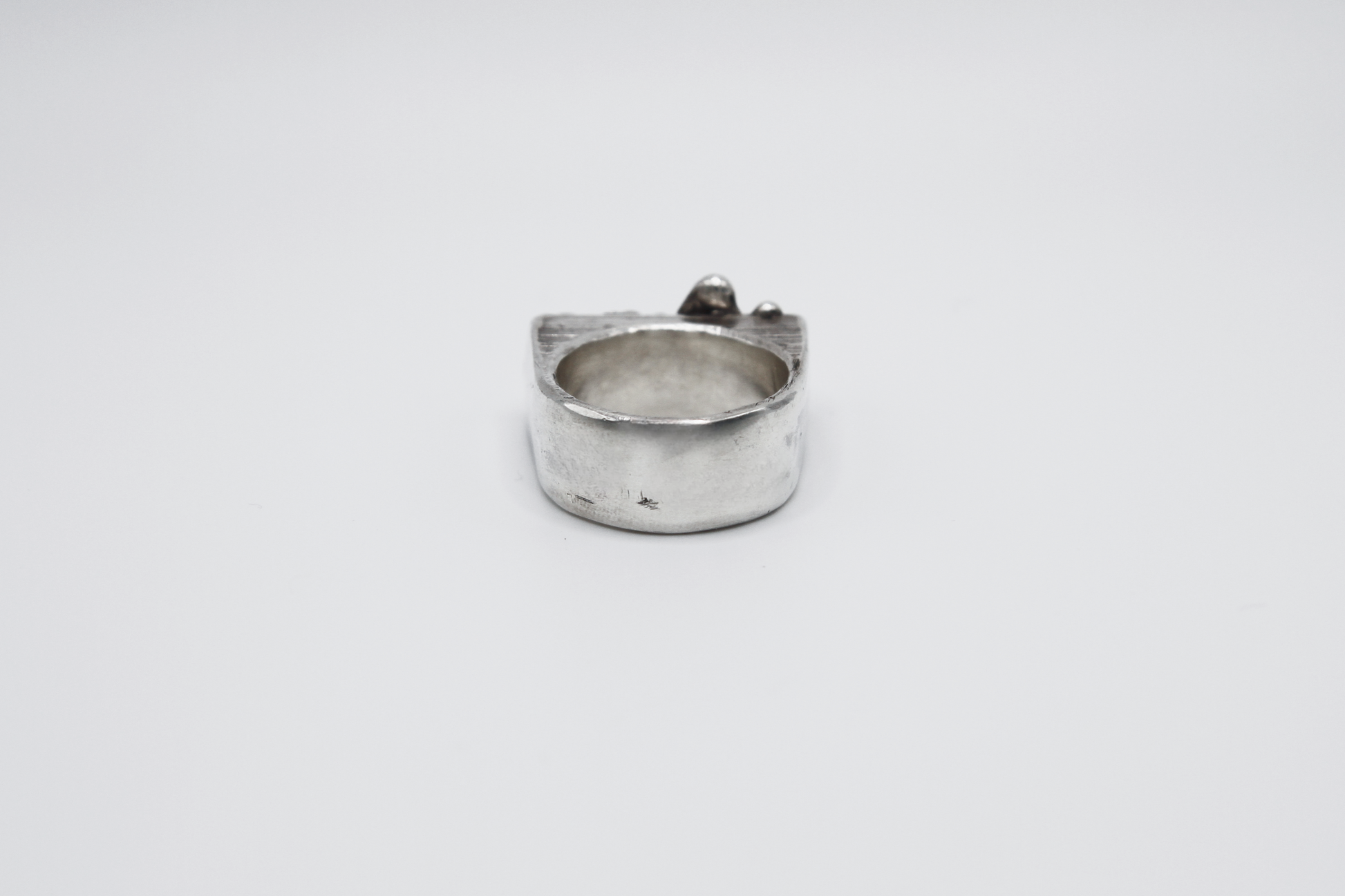 The Treacle Signet Ring. 925 Solid Sterling Silver Chunky Ring hand made in the United Kingdom. This ring has a rectangular face with drips of sterling silver giving a melted and organic look. For all genders and ring sizes.