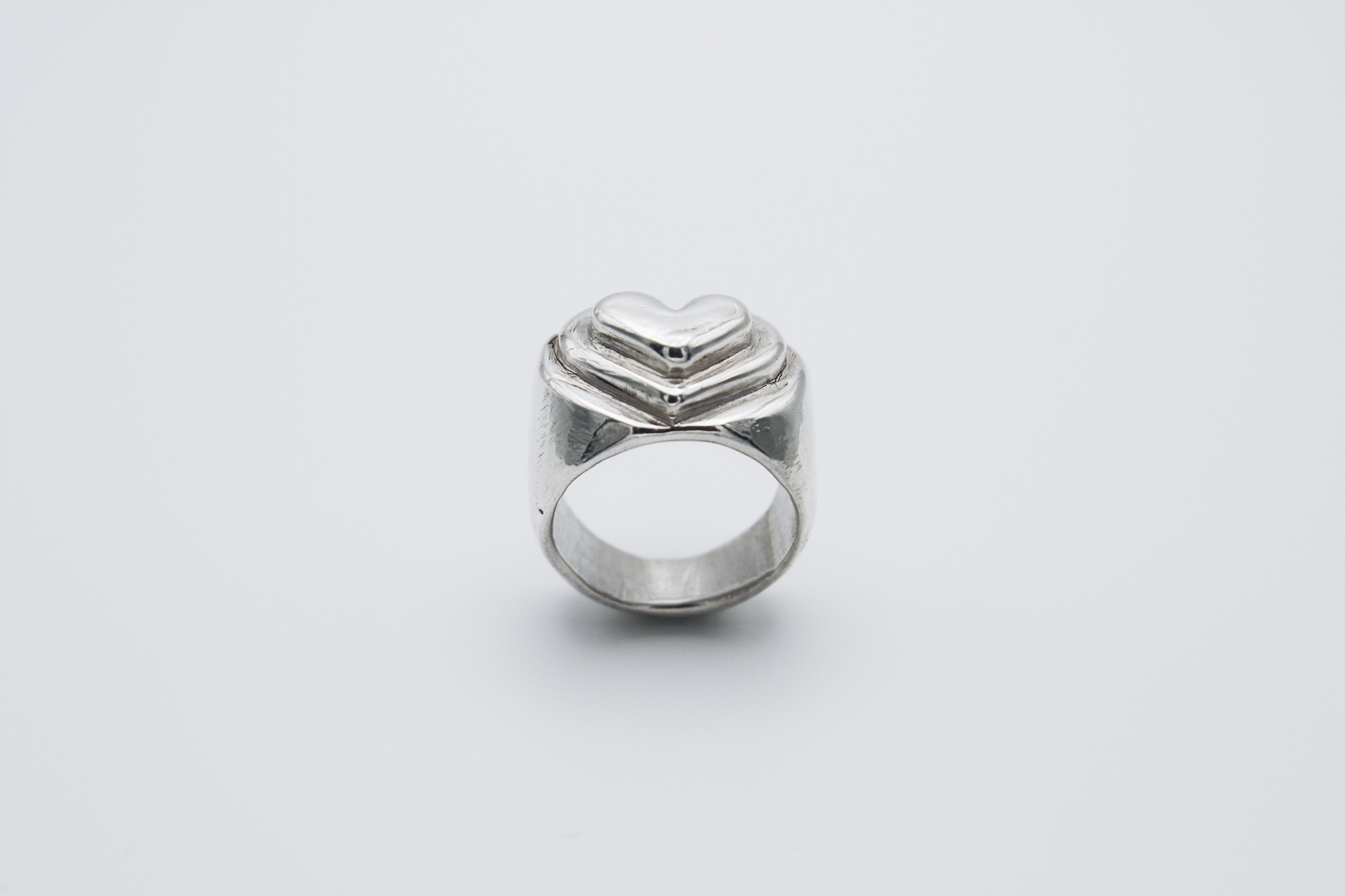 The Hill of Hearts Ring. 925 Solid Sterling Silver Chunky Ring hand made in the United Kingdom. This ring is made up of 3 tiers in a heart shape carved by hand from wax and then cast into sterling silver. For all genders and ring sizes.
