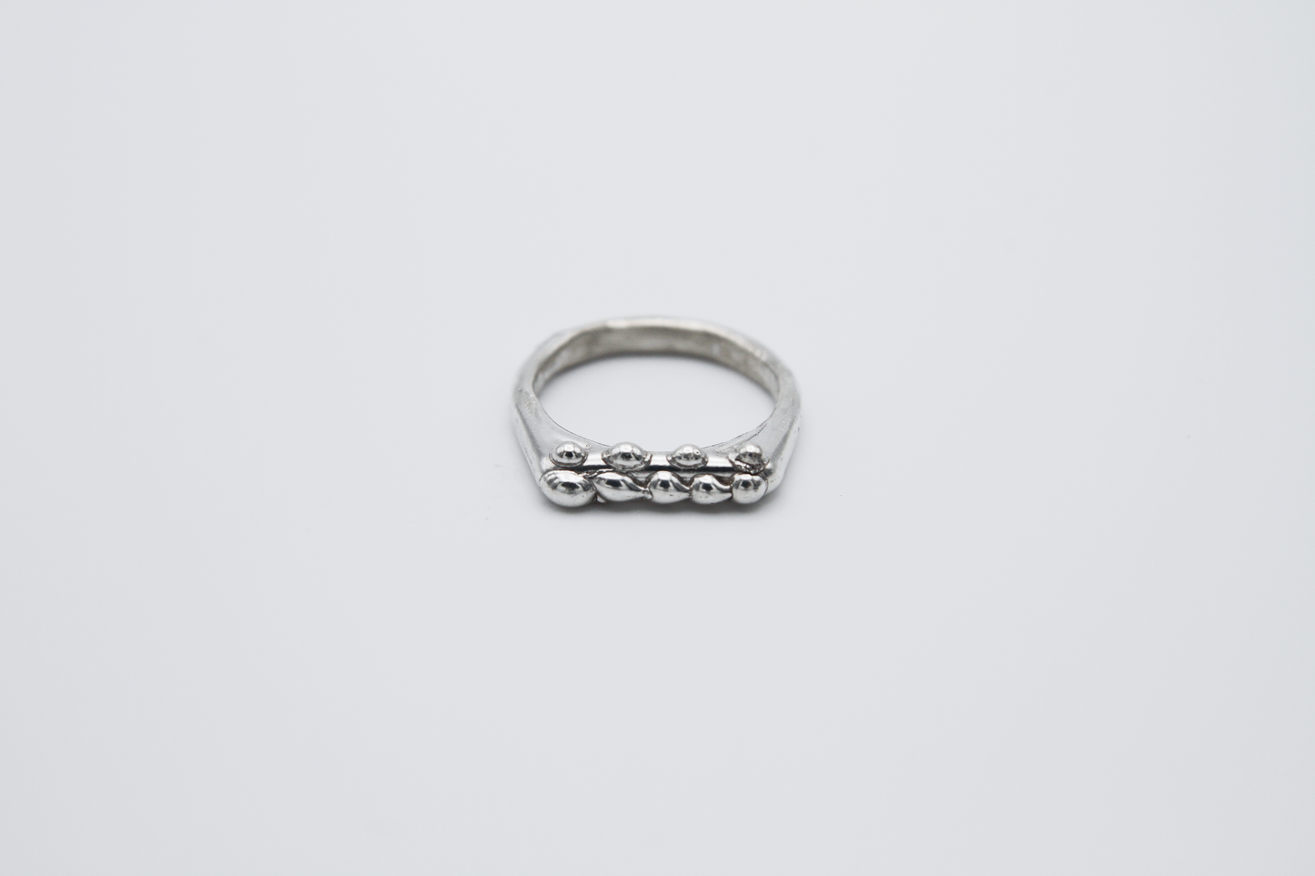 The Dew Drop Signet Ring Stack. 925 Solid Sterling Silver Chunky Ring band hand made in the United Kingdom. These stacking rings fashion blobs and drops of sterling silver in a bespoke and organic deisgn. Stack these three rings however you like, to be worn together or separately. For all genders and ring sizes.