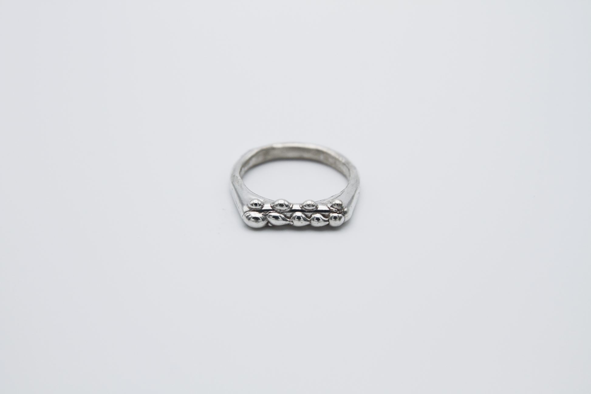 The Dew Drop Signet Ring Stack. 925 Solid Sterling Silver Chunky Ring band hand made in the United Kingdom. These stacking rings fashion blobs and drops of sterling silver in a bespoke and organic deisgn. Stack these three rings however you like, to be worn together or separately. For all genders and ring sizes.