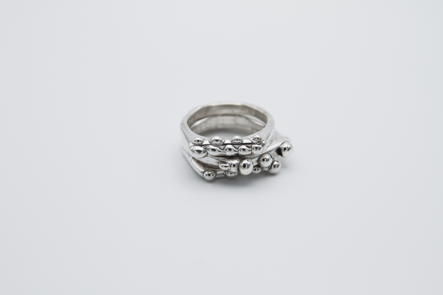 The Dew Drop Signet Ring Stack. 925 Solid Sterling Silver Chunky Ring band hand made in the United Kingdom. These stacking rings fashion blobs and drops of sterling silver in a bespoke and organic deisgn. Stack these three rings however you like, to be worn together or separately. For all genders and ring sizes.