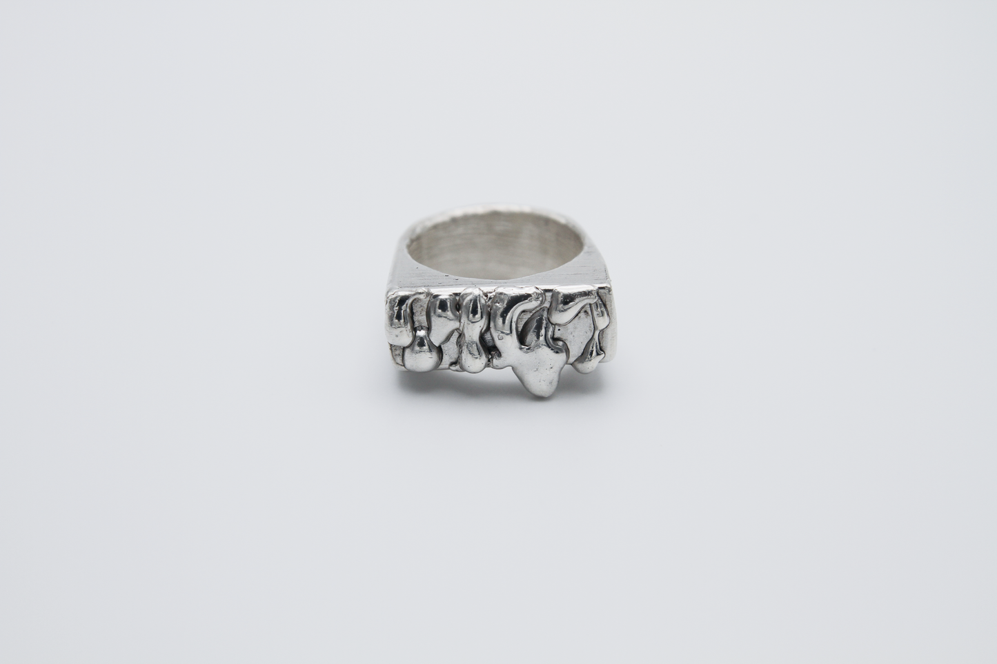 The Treacle Signet Ring. 925 Solid Sterling Silver Chunky Ring hand made in the United Kingdom. This ring has a rectangular face with drips of sterling silver giving a melted and organic look. For all genders and ring sizes.