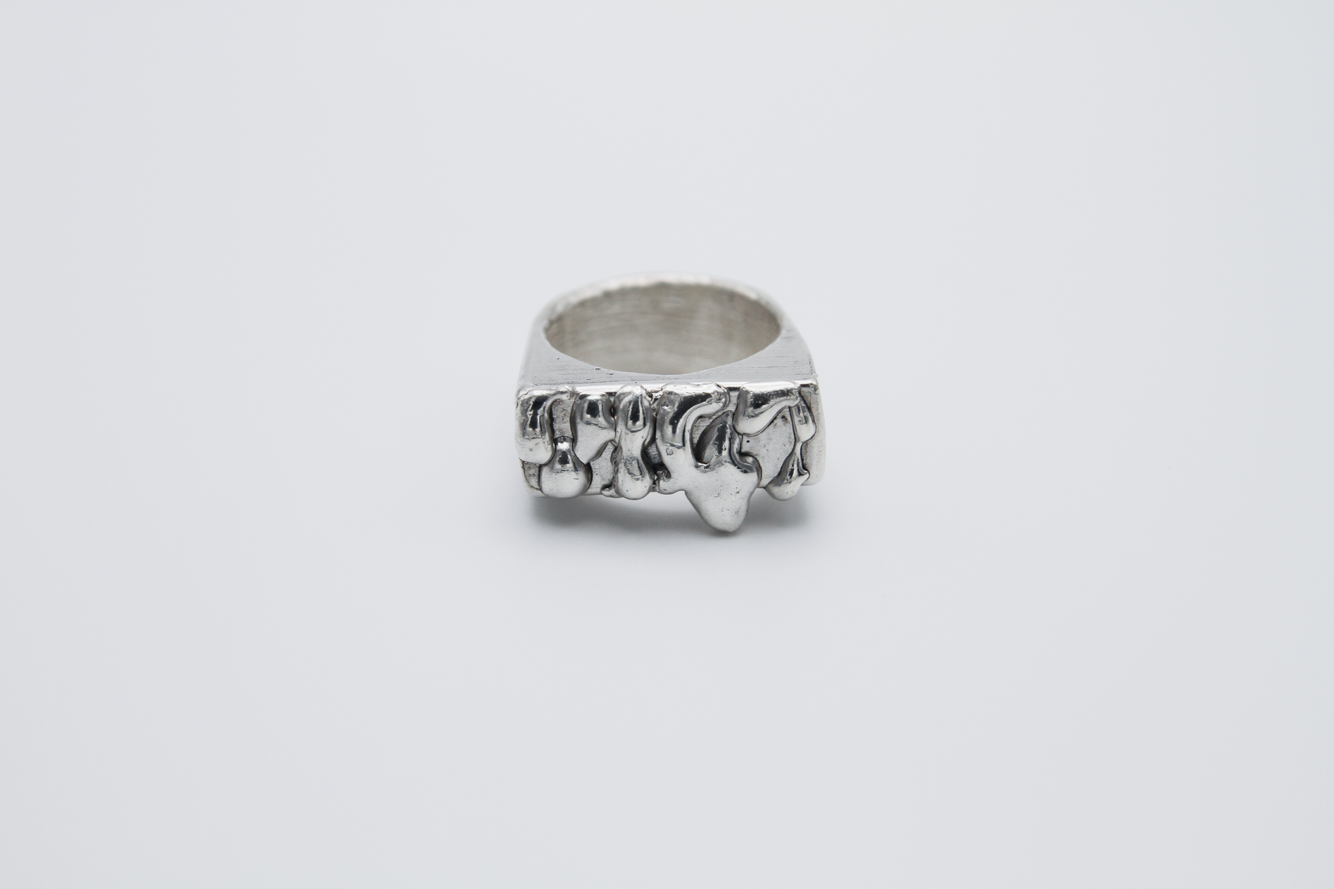 The Treacle Signet Ring. 925 Solid Sterling Silver Chunky Ring hand made in the United Kingdom. This ring has a rectangular face with drips of sterling silver giving a melted and organic look. For all genders and ring sizes.